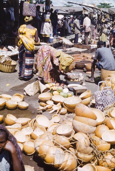 A gourd stall at Abidjan market. A gourd stall at a bustling market in Abidjan. Abidjan, Cote d'Ivoire, circa 1960. Cote d'Ivoire, Western Africa, Africa.