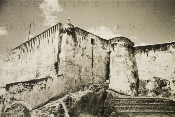 Fort Jesus on Mombasa Island. The defensive outer wall and watchtower of Fort Jesus. At the time of this photograph, and up until 1958 while Kenya was a British colony, the fort was used as a government prison. Mombasa, Kenya, 1933. Mombasa, Coast, Kenya, Eastern Africa, Africa.