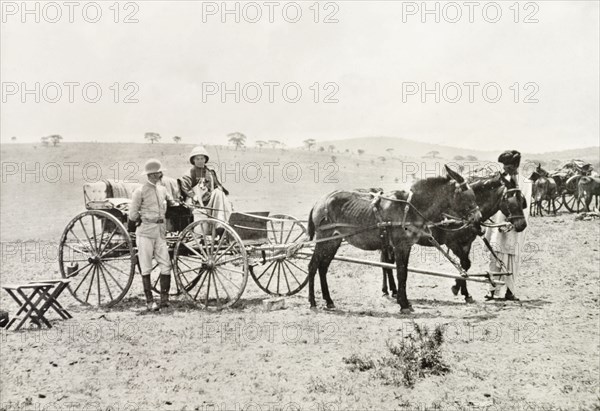 A Uganda Railways Chief Engineer. A Uganda Railways Chief Engineer stands beside a horse-drawn carriage containing a European woman and her dog. East Province, British East Africa (Kenya), 1896., East (Kenya), Kenya, Eastern Africa, Africa.