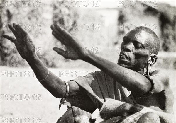 Debating at a Kikuyu council. A Kikuyu 'njama' (elder) talks animatedly during a debate at a 'kiana' (council of elders). South Nyeri, Kenya, 1936. Nyeri, Central (Kenya), Kenya, Eastern Africa, Africa.