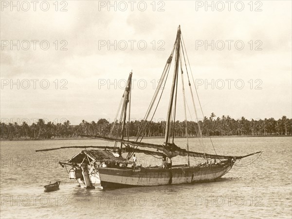 A batella on the Baliapatuam River. A traditional Indian battela (cargo boat) travels along the Baliapatuam River in northern Malabar. Malabar District (Kerala), India, circa 1936., Kerala, India, Southern Asia, Asia.
