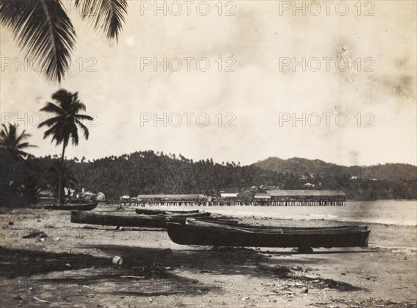 Port Maria beach. Fishing canoes sit on a sandy shore at Port Maria. Port Maria, Jamaica, circa 1921. Port Maria, St Mary (Jamaica), Jamaica, Caribbean, North America .