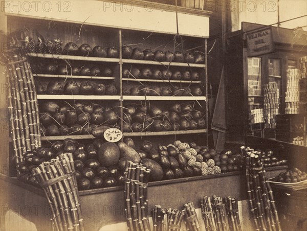 Fruit stall at a Cuban market. A fruit stall at a Cuban market sells melons, pineapples and bundles of cut sugar cane. Cuba, circa 1927. Cuba, Caribbean, North America .