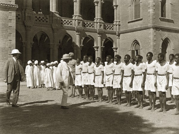 Rudolf von Slatin visits Gordon College. Sir Rudolf Carl von Slatin inspects a line of uniformed African students outside Gordon College. Khartoum, Sudan, 1926. Khartoum, Khartoum, Sudan, Eastern Africa, Africa.