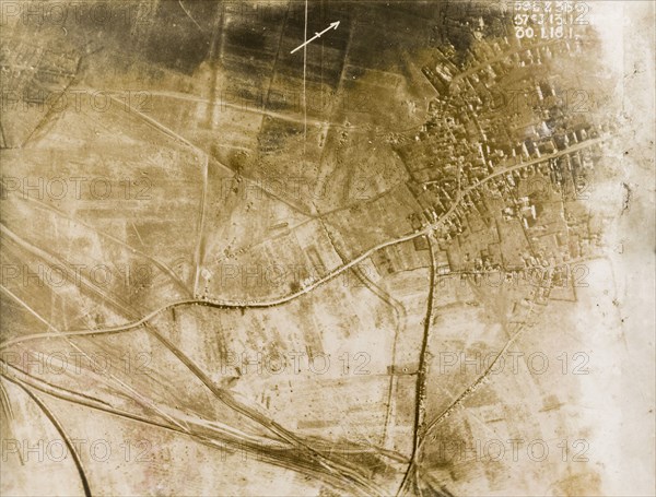 Aerial view of a bomb-damaged village. One of a series of British aerial reconnaissance photographs recording the positions of trenches on the Western Front during the First World War. The remains of a bomb-damaged village, surrounded by fields pockmarked with bomb craters. Nord-Pas de Calais or Picardie, France, 30 January 1918., Nord-Pas de Calais, France, Western Europe, Europe .