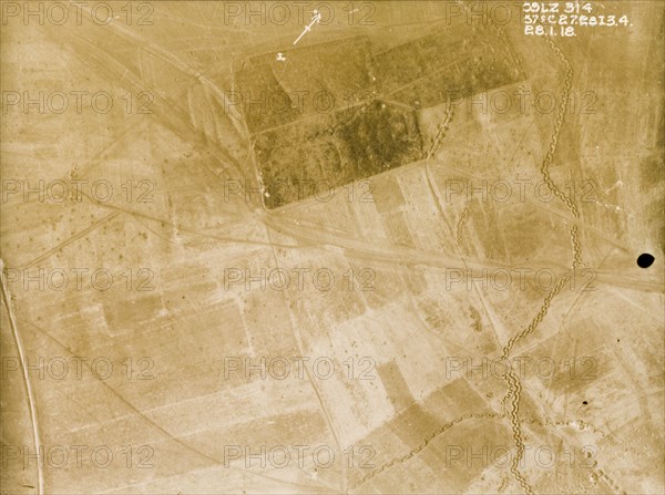 Position of a British Field Battery Company. One of a series of British aerial reconnaissance photographs recording the positions of trenches on the Western Front during the First World War. An original caption indicates the position of a British Field Battery Company within the darker area of plantation at the top of the image. A strongly fortified trench zig-zags its way across fields to the east. Nord-Pas de Calais or Picardie, France, 28 January 1918., Nord-Pas de Calais, France, Western Europe, Europe .