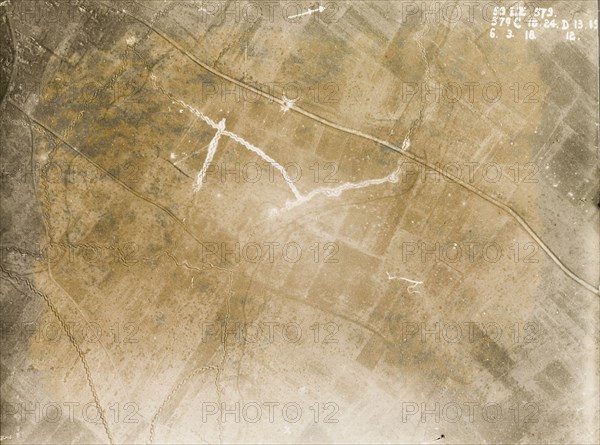 Aerial view of surrendered German territory. One of a series of British aerial reconnaissance photographs recording the positions of trenches on the Western Front during the First World War. A small white circle on the main road indicates the explosion point of a mine, apparently detonated by the German army when they surrendered territory to the British. Nord-Pas de Calais or Picardie, France, 6 March 1918., Nord-Pas de Calais, France, Western Europe, Europe .