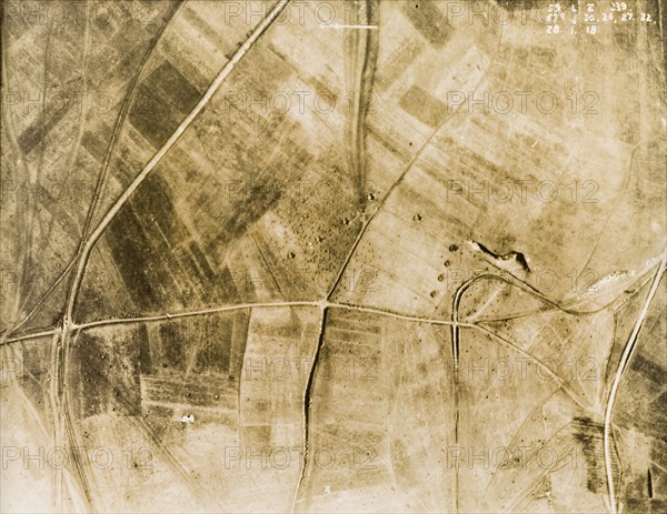 Gun pits and light railway tracks. One of a series of British aerial reconnaissance photographs recording the positions of trenches on the Western Front during the First World War. An original caption points out ammunition transport tracks running towards a row of gun pits near the central crossroad. Two light railway tracks are also identified: one running east to west on left of the image, the other looping around on the right. Nord-Pas de Calais or Picardie, France, 28 January 1918., Nord-Pas de Calais, France, Western Europe, Europe .