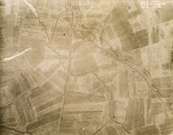Aerial view of a trench system. One of a series of British aerial reconnaissance photographs recording the positions of trenches on the Western Front during the First World War. An intricate trench system, probably British, zig-zags its way across a patchwork of fields. An original caption indicates no man's land as the area in the top right hand corner, bordered by dark lines of barbed wire protecting the front line to the south. Nord-Pas de Calais or Picardie, France, 17 February 1918., Nord-Pas de Calais, France, Western Europe, Europe .