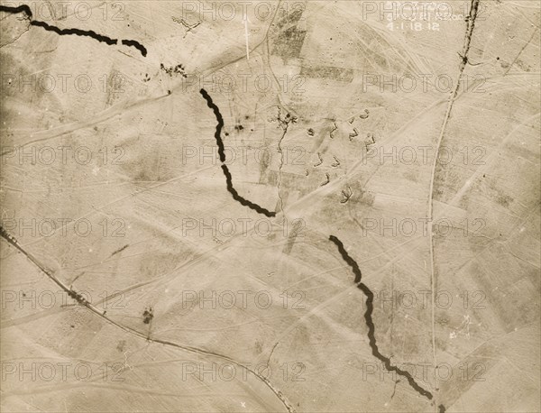 Aerial view of the Western Front under snow. One of a series of British aerial reconnaissance photographs recording the positions of trenches on the Western Front during the First World War. A thick belt of barbed wire runs north to south, contrasting sharply with the snow-covered battlefield. An original caption indicates the position of the 51st (Highland) Division of the British Army, stationed in a gap in the wire at the top of the image. Nord-Pas de Calais or Picardie, France, 4 January 1918., Nord-Pas de Calais, France, Western Europe, Europe .