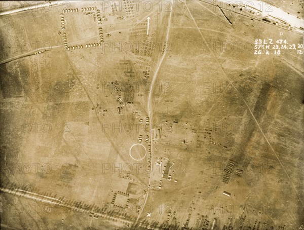 A British military camp on the Western front. One of a series of British aerial reconnaissance photographs recording the positions of trenches on the Western Front during the First World War. An original caption identifies various features inside a British military camp, including a square of Nissen huts (top left) and a set of circular earthworks built to protect bell tents by the roadside (top, centre). Nord-Pas de Calais or Picardie, France, 26 February 1918., Nord-Pas de Calais, France, Western Europe, Europe .