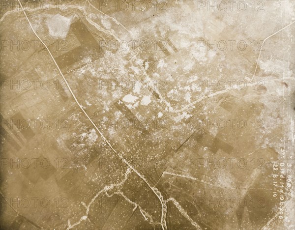 Fields riddled with trenches and bomb craters. One of a series of British aerial reconnaissance photographs recording the positions of trenches on the Western Front during the First World War. A road runs through a patchwork of fields riddled with trenches and bomb craters. Nord-Pas de Calais or Picardie, France, 22 August 1917., Nord-Pas de Calais, France, Western Europe, Europe .