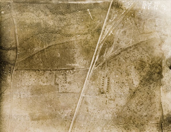 Aerial view of a bomb-damaged landscape. One of a series of British aerial reconnaissance photographs recording the positions of trenches on the Western Front during the First World War. The landscape surrounding a military camp is riddled with trenches and bomb craters. Nord-Pas de Calais or Picardie, France, 18 February 1918. France, Western Europe, Europe .