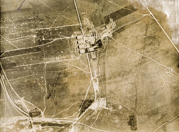 Aerial view of a military camp on the Western Front. One of a series of British aerial reconnaissance photographs recording the positions of trenches on the Western Front during the First World War. A number of transport tracks lead towards a military camp, which is defended on one side by a square-toothed trench. Nord-Pas de Calais or Picardie, France, 1917-18., Nord-Pas de Calais, France, Western Europe, Europe .