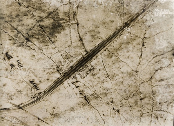 A railway track on the Western Front. One of a series of British aerial reconnaissance photographs recording the positions of trenches on the Western Front during the First World War. A railway line runs north to west through snow-covered fields, surrounded by an intricate system of trenches and transport tracks. Nord-Pas de Calais or Picardie, France, 6 January 1918., Nord-Pas de Calais, France, Western Europe, Europe .