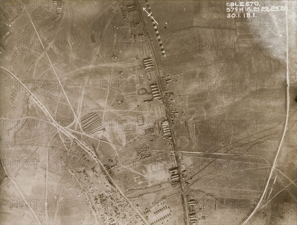 Aerial view of a military camp on the Western Front. One of a series of British aerial reconnaissance photographs recording the positions of trenches on the Western Front during the First World War. Trenches and transport tracks surround a military camp, probably British, based along a road running north to south. Nord-Pas de Calais or Picardie, France, 30 January 1918., Nord-Pas de Calais, France, Western Europe, Europe .