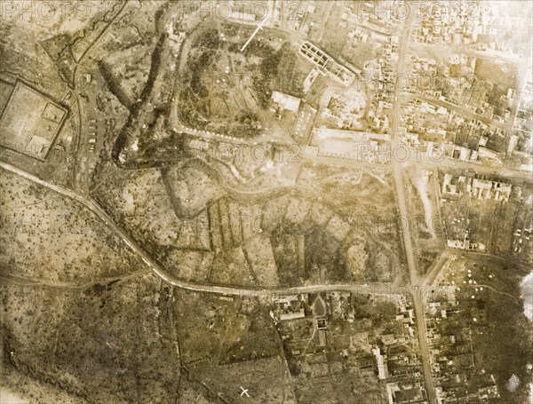 Aerial view of a bomb-damaged village. One of a series of British aerial reconnaissance photographs recording the positions of trenches on the Western Front during the First World War. A small French village lies in ruins, riddled with bomb craters, after suffering a continuous barrage of artillery fire. Nord-Pas de Calais or Picardie, France, 3 February 1918., Nord-Pas de Calais, France, Western Europe, Europe .