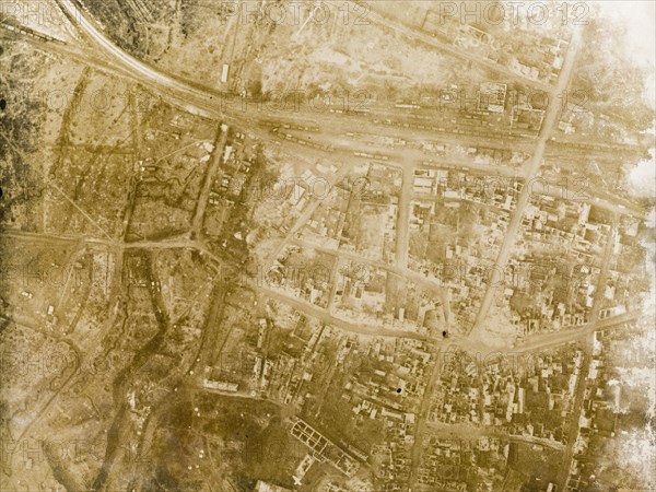 Aerial view of a bomb-damaged village. One of a series of British aerial reconnaissance photographs recording the positions of trenches on the Western Front during the First World War. A small French village lies in ruins, riddled with bomb craters, after suffering a continuous barrage of artillery fire. Nord-Pas de Calais or Picardie, France, 3 February 1918., Nord-Pas de Calais, France, Western Europe, Europe .
