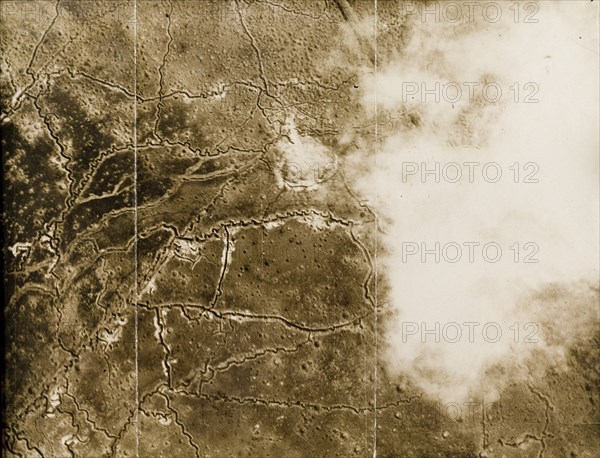 Aerial view of a trench system on the Western Front. One of a series of British aerial reconnaissance photographs recording the positions of trenches on the Western Front during the First World War. Cloud cover partially obscures a battlefield riddled with trenches and bomb craters. Nord-Pas de Calais or Picardie, France, circa 1918., Nord-Pas de Calais, France, Western Europe, Europe .