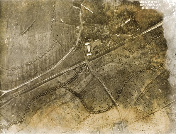 Trenches and bomb damage on the Western Front. One of a series of British aerial reconnaissance photographs recording the positions of trenches on the Western Front during the First World War. Square-toothed trenches and fields pockmarked with bomb craters surround a cluster of isolated buildings, possibly a farm. Nord-Pas de Calais or Picardie, France, 16 February 1918., Nord-Pas de Calais, France, Western Europe, Europe .