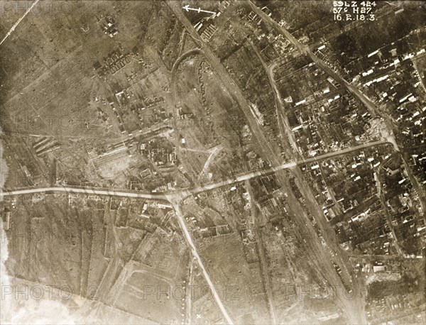 Aerial view of a bomb-damaged village. One of a series of British aerial reconnaissance photographs recording the positions of trenches on the Western Front during the First World War. A small French village lies in ruins, riddled with bomb craters, after suffering a continuous barrage of artillery fire. Nord-Pas de Calais or Picardie, France, 16 February 1918., Nord-Pas de Calais, France, Western Europe, Europe .