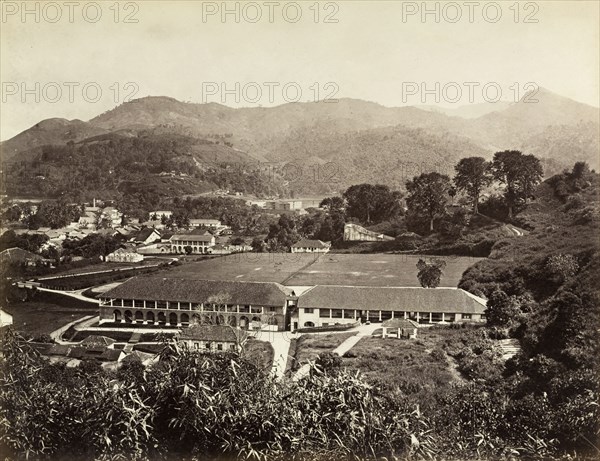 The Barracks', Kandy. A double-storey colonnaded building with a recreation ground. Identified by an original caption as 'The Barracks', this is possibly a military base of the British Army. Kandy, Sri Lanka, circa 1885. Kandy, Central (Sri Lanka), Sri Lanka, Southern Asia, Asia.