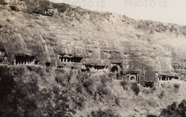 Ajanta caves. A number of pillared entrances carved into the Ajanta ravine mark the location of the Ajanta caves, a series of ancient caves that feature Buddhist religious art including ornate frescoes and sculptures. Near Aurangabad, Bombay Presidency (Maharashtra), India, circa 1926. Aurangabad, Maharashtra, India, Southern Asia, Asia.