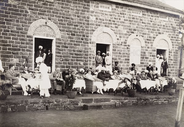 Maharajah of Kolhapur hosts the Acting Governor of Bombay. The Acting Governor of Bombay, Sir Henry Staveley Lawrence, watches an outdoor event with the Maharajah of Kolhapur, Rajaram II Bonsle (r.1922-40), and other dignitaries during his official visit to Kolhapur. Kolhapur, Kolhapur State (Maharashtra), India, 14 October 1925. Kolhapur, Maharashtra, India, Southern Asia, Asia.