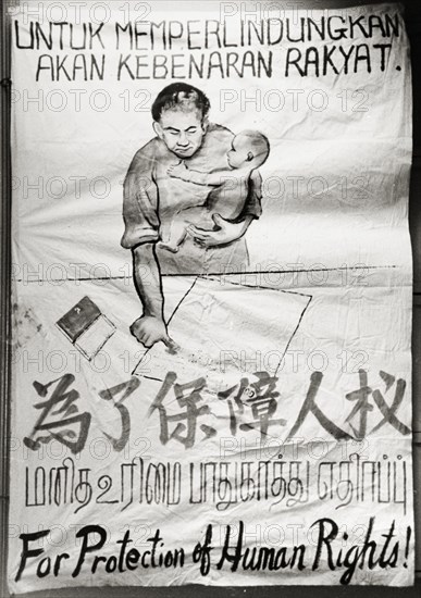 Singaporean human rights poster. A hand-painted banner campaigns for the protection of human rights as part of the Singaporean Merdeka (independence) movement of the 1950s. The text reads 'For Protection of Human Rights' and is written in Malay, Chinese, Tamil and English script. Singapore, circa 1956. Singapore, South East Asia, Asia.