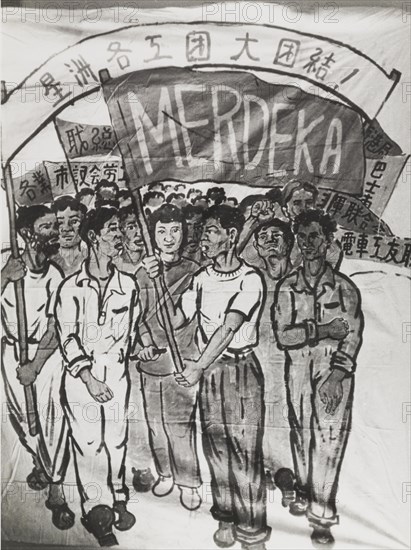 Campaigning for Merdeka. A hand-painted banner depicts a Singaporean crowd campaigning for Merdeka (independence from the United Kingdom). They carry flags and banners written in Malay, Chinese and English script. Singapore, circa 1956. Singapore, South East Asia, Asia.