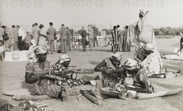 Crafts at Kaduna Children's Village. A group of young women from Kaduna Children's Village demonstrate Nigerian craft skills during a visit from Queen Elizabeth II and the Duke of Edinburgh. Kaduna, Nigeria, February 1956. Kaduna, Kaduna, Nigeria, Western Africa, Africa.