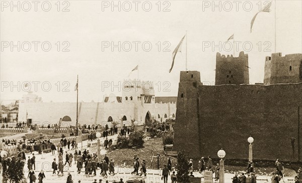 British Empire Exhibition at Wembley. Crowds visit replicas of buildings from the Gold Coast (Ghana) and British East Africa, which have been re-constructed on a grand scale for the British Empire Exhibition at Wembley. London, England, 1924. London, London, City of, England (United Kingdom), Western Europe, Europe .