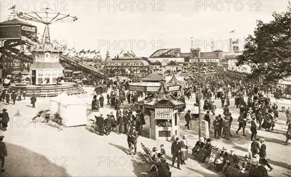 Fairground at British Empire Exhibition. Bustling crowds explore the fairground rides and stalls at the British Empire Exhibition at Wembley. London, England, 1924. London, London, City of, England (United Kingdom), Western Europe, Europe .