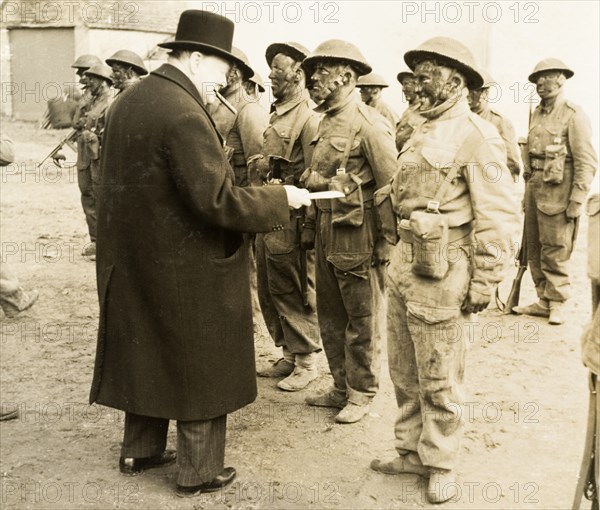 Winston Churchill meets Royal Engineers. British Prime Minister, Sir Winston Churchill (1874-1965), addresses a line up of muddy-faced soldiers in the Second Division of the Royal Engineers. The division were deployed to India in 1942, the same year that Churchill produced his 'Report to the House of Commons on the Policy of the British Government in India'. Probably England, April 1942. England (United Kingdom), Western Europe, Europe .