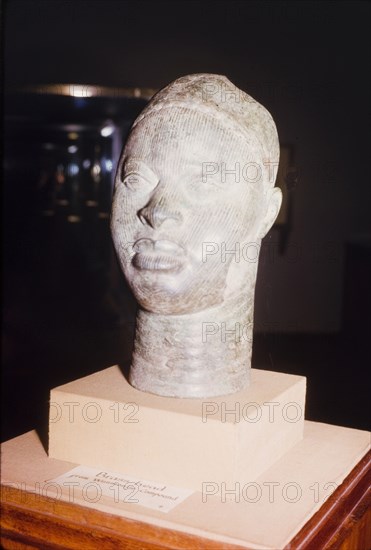 Yoruba bronze sculpture. A bronze sculpture of a head, possibly a royal or religious effigy, from the ancient Yoruba city of Ife. The Yoruba custom of sculpting figures flourished during the 14th and 15th centuries, when they began making life-like bronze sculptures. Ife, Nigeria, 1963. Ife, Osun, Nigeria, Western Africa, Africa.