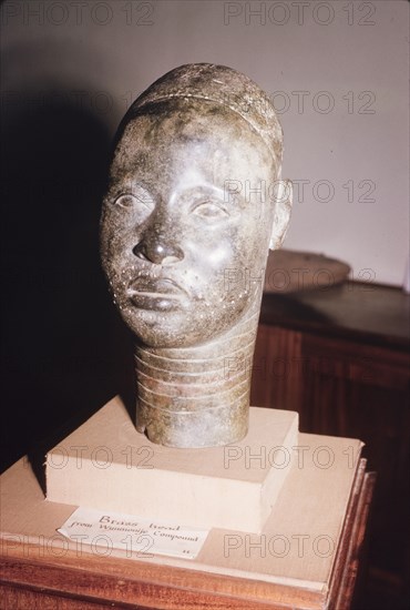Yoruba bronze sculpture. A bronze sculpture of a head, possibly a royal or religious effigy, from the ancient Yoruba city of Ife. The Yoruba custom of sculpting figures flourished during the 14th and 15th centuries, when they began making life-like bronze sculptures. Ife, Nigeria, 1963. Ife, Osun, Nigeria, Western Africa, Africa.
