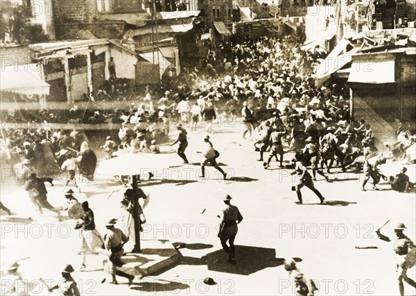 Riots in Jaffa, 1936. Rioting crowds of Palestinian Arabs disperse in chaos as British military forces attempt to control them during the Great Uprising, a revolt against Jewish immigration that lasted from 1936 to 1939. Jaffa, Palestine (Israel), 5 June 1936. Jaffa, Tel Aviv, Israel, Middle East, Asia.