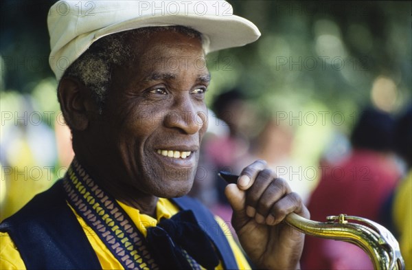 Saxophonist at the Caribbean Music Village. A saxophonist prepares to play at the Caribbean Music Village, a cultural festival held at the Commonwealth Institute. London, England, 7-26 July 1986. London, London, City of, England (United Kingdom), Western Europe, Europe .