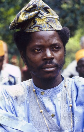 Man in traditional African dress. Portrait of a man in traditional African dress at the West African Music Village, a cultural festival held at the Commonwealth Institute. London, England, 1989. London, London, City of, England (United Kingdom), Western Europe, Europe .