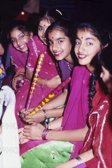 Girls in traditional Indian dress. Girls in traditional Indian dress celebrate Diwali, the Hindu festival of light, during a mela (fair) at the Commonwealth Institute. London, England, circa 1985. London, London, City of, England (United Kingdom), Western Europe, Europe .