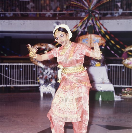 Hindu dancing at a Diwali mela. A female dancer in traditional Indian dress performs at a mela (fair) during Diwali, the Hindu festival of light. London, England, circa 1985. London, London, City of, England (United Kingdom), Western Europe, Europe .