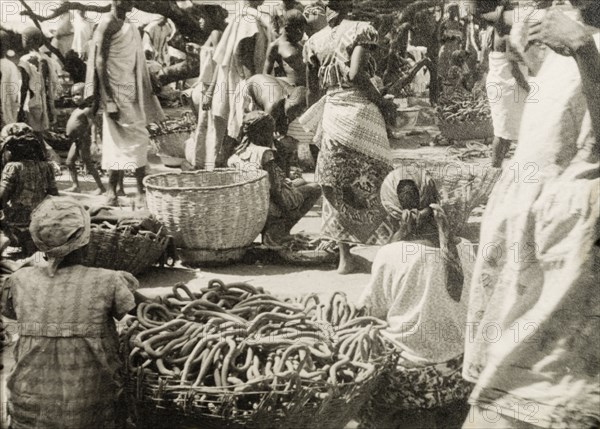 Pretzel stalls at a Ghanaian market. Female traders sell baskets full of pretzels at a busy market in the Northern Territories. Gold Coast (Northern Ghana), circa 1950., North (Ghana), Ghana, Western Africa, Africa.