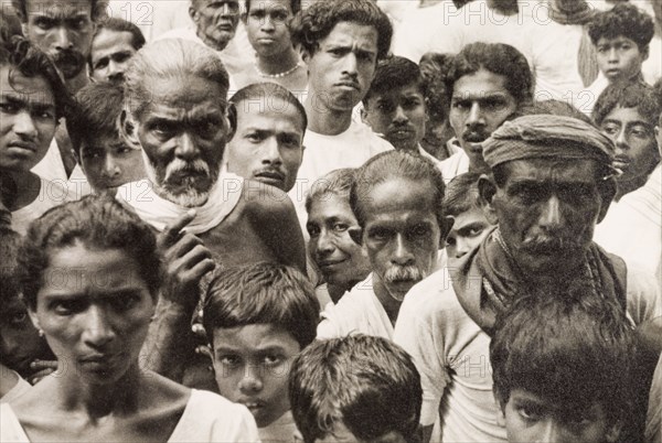 A crowd of Ceylonian people. A tightly packed crowd of people gaze solemnly into the camera. Ceylon (Sir Lanka), 1936. Sri Lanka, Southern Asia, Asia.