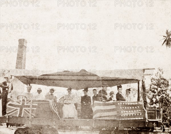 American missionaries in Jamaica. A group of American missionaries travels in an open rail carriage decorated with British and American flags. Jamaica, circa 1890. Jamaica, Caribbean, North America .