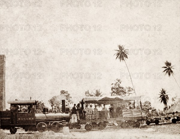 American missionaries in Jamaica. A group of American missionaries travels in an open rail carriage decorated with British and American flags. Jamaica, circa 1890. Jamaica, Caribbean, North America .