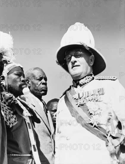 Sir Phillip Mitchell greets African chiefs. Sir Phillip Mitchell (1890-1964), the Governor of Kenya, greets African chiefs at an assembly to welcome Princess Elizabeth at Eastleigh Airport. Nairobi, Kenya, February 1952. Nairobi, Nairobi Area, Kenya, Eastern Africa, Africa.