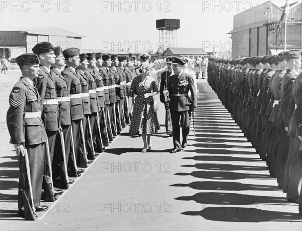 Princess Elizabeth inspects a Guard of Honour. Princess Elizabeth is accompanied by a British military officer and government officials as she inspects a Guard of Honour on her arrival at Eastleigh Airport. Nairobi, Kenya, February 1952. Nairobi, Nairobi Area, Kenya, Eastern Africa, Africa.