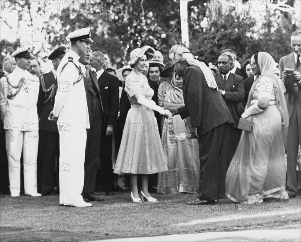 Princess Elizabeth greets Asian dignitaries. Princess Elizabeth and the Duke of Edinburgh greet Asian dignitaries during an official garden party at Government House. Nairobi, Kenya, February 1952. Nairobi, Nairobi Area, Kenya, Eastern Africa, Africa.