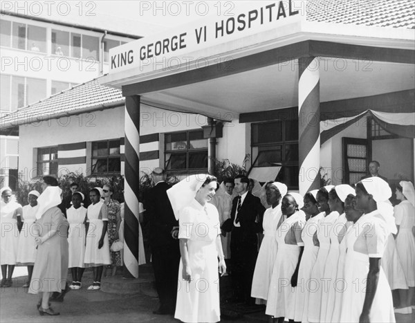 Hospital staff prepare for a royal visit. Nurses and hospital officials assemble outside the King George VI Hospital (now Kenyatta National Hospital), in preparation for a visit by the Duke of Edinburgh. Nairobi, Kenya, February 1952. Nairobi, Nairobi Area, Kenya, Eastern Africa, Africa.