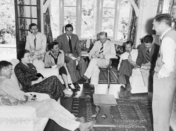 Kenyan press conference for the death of King George VI. A group of European journalists gather inside the Royal Lodge at Nyeri for a press conference announcing the death of King George VI. The lodge was presented to Princess Elizabeth and the Duke of Edinburgh by the people of Kenya in 1952, but was not immediately visited by the royal couple, whose official tour of Kenya was cut unexpectedly short by the King's death on 6 February. Nyeri, Kenya, circa 6 February 1952. Nyeri, Central (Kenya), Kenya, Eastern Africa, Africa.